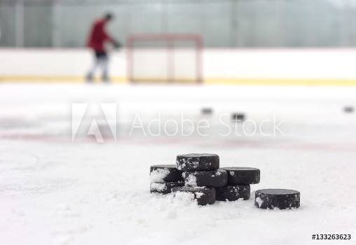 Picture of Hockey player with pucks